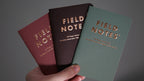 Lucky Field Notes fanned out against light